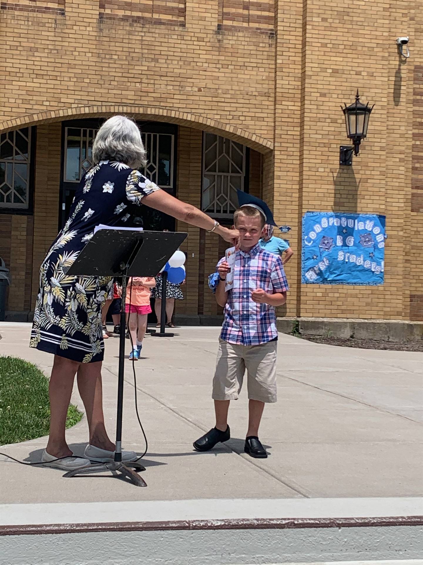 Principal hands certificate to student