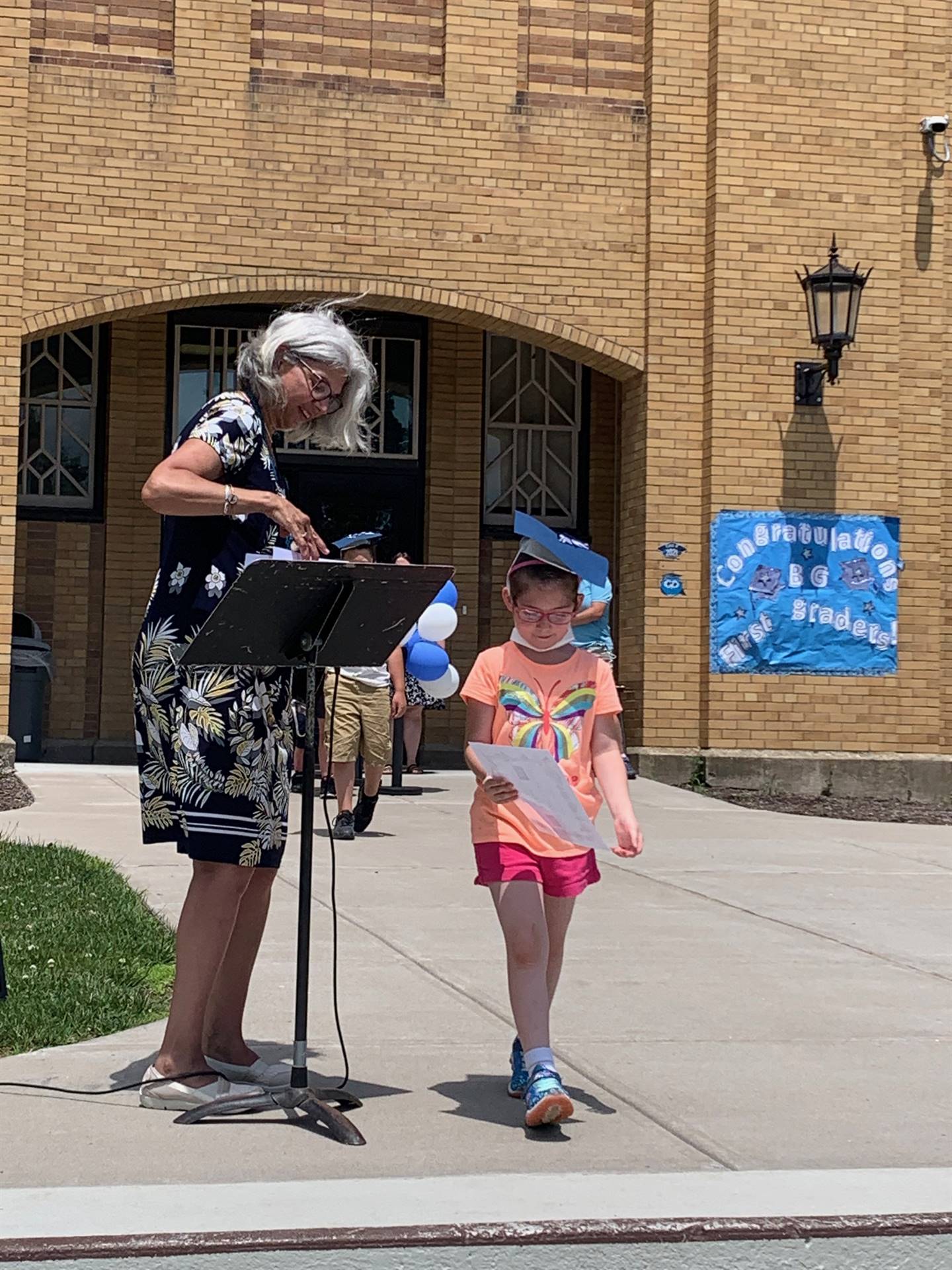 Principal hands certificate to student