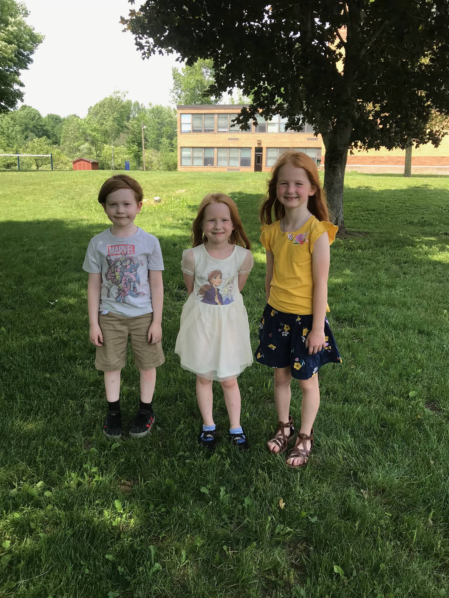 3 students stand together.