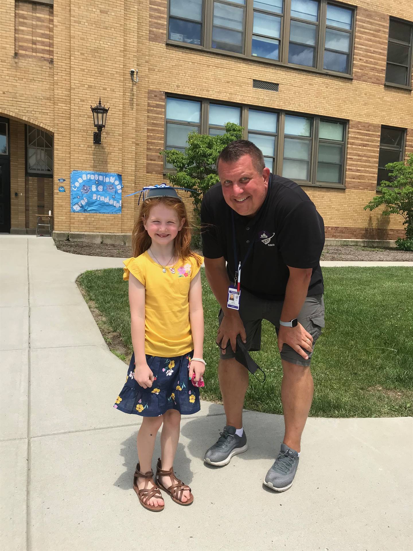 a student stands with Student resource officer