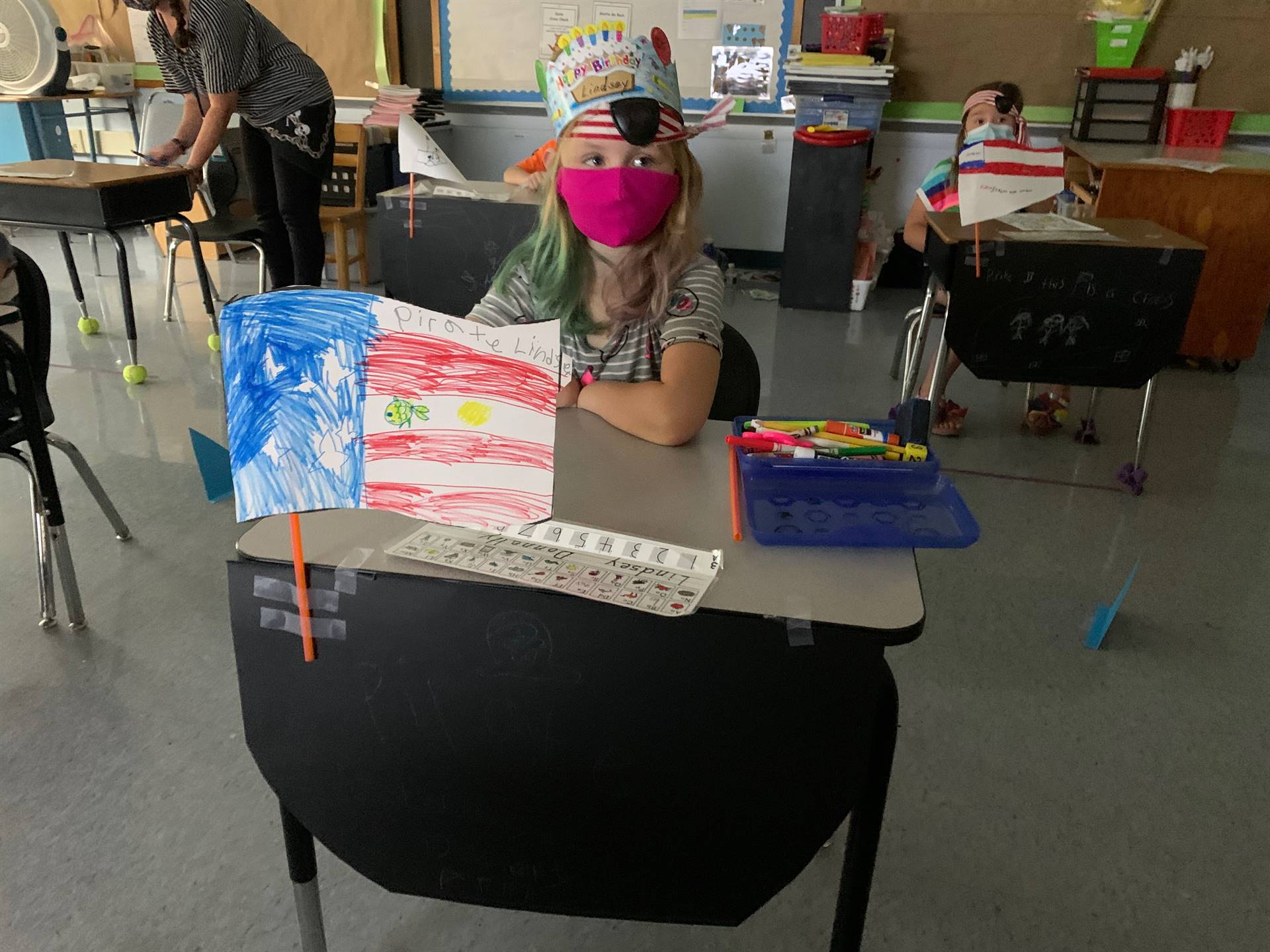 a student sitting at a desk decorated as a pirate ship.