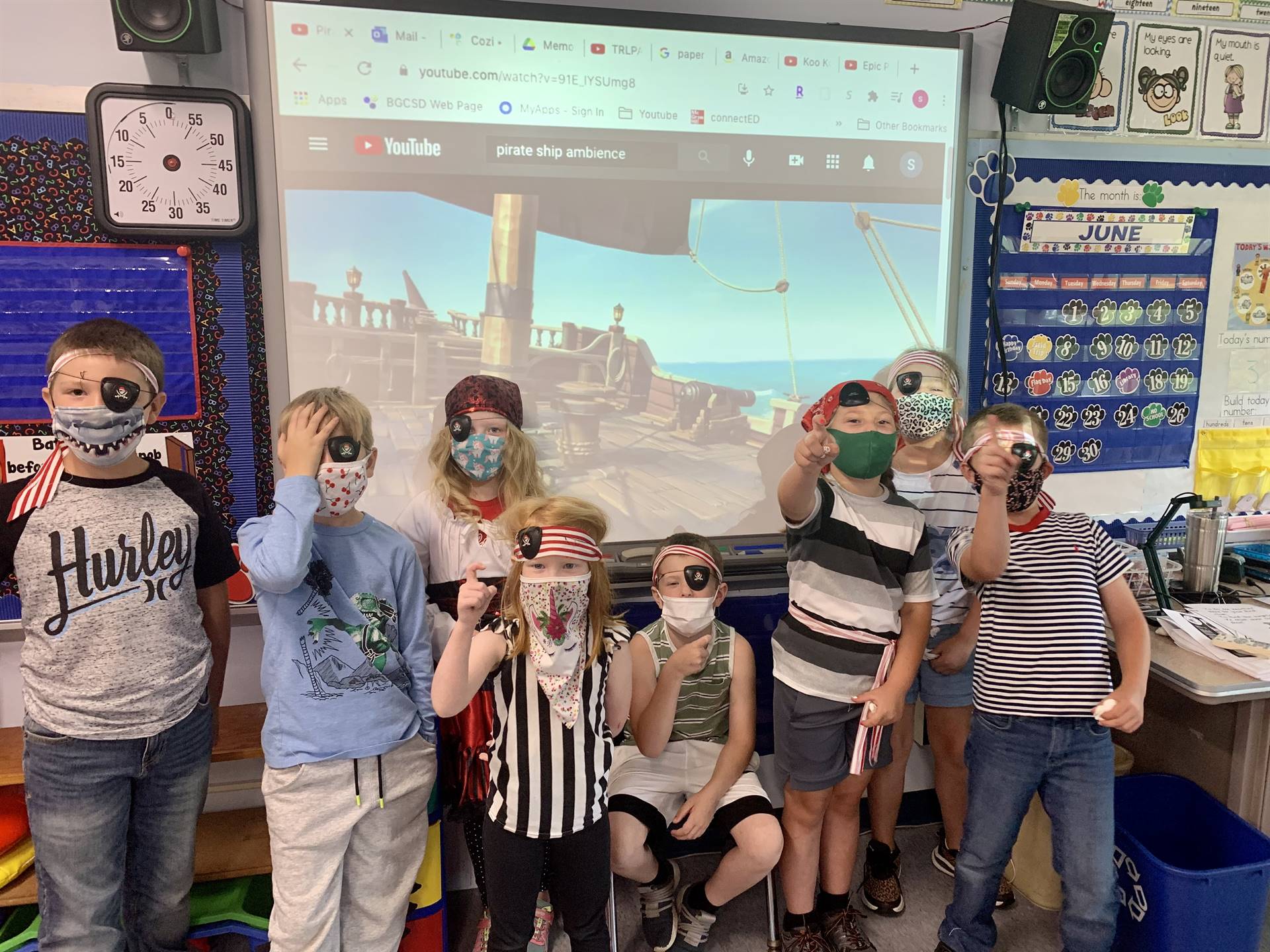 A group of students with pirate ship in background