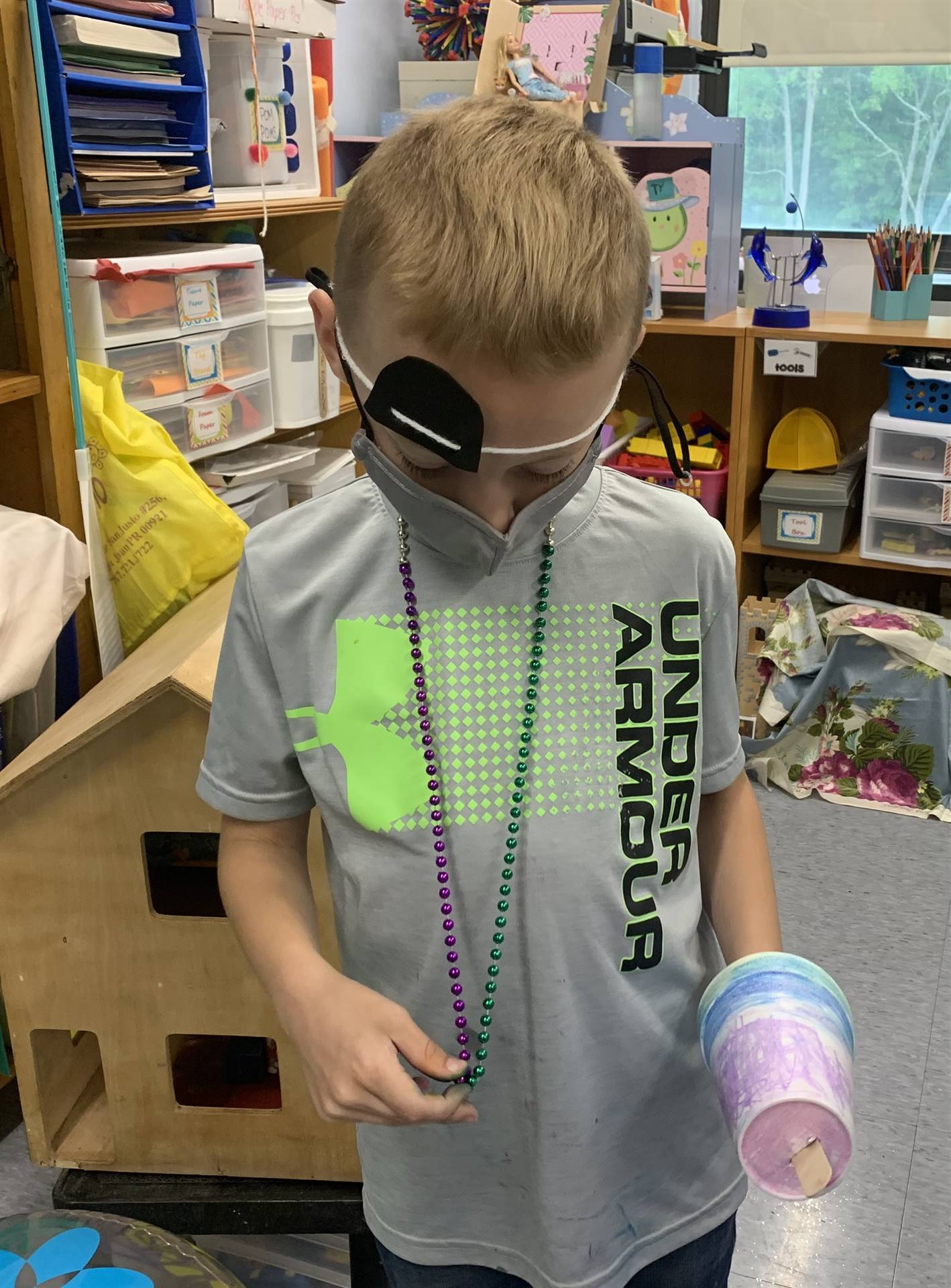 a student pirate shows off treasure and a "claw" hook hand.