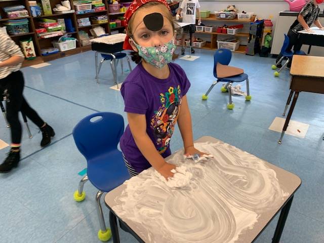 student pirate washes desk ("deck")