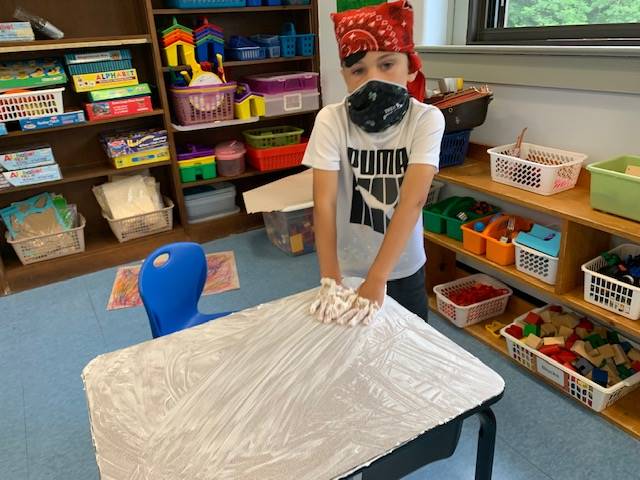 student pirate washes desk ("deck")