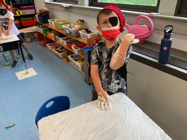 student pirate washes desk ("deck")