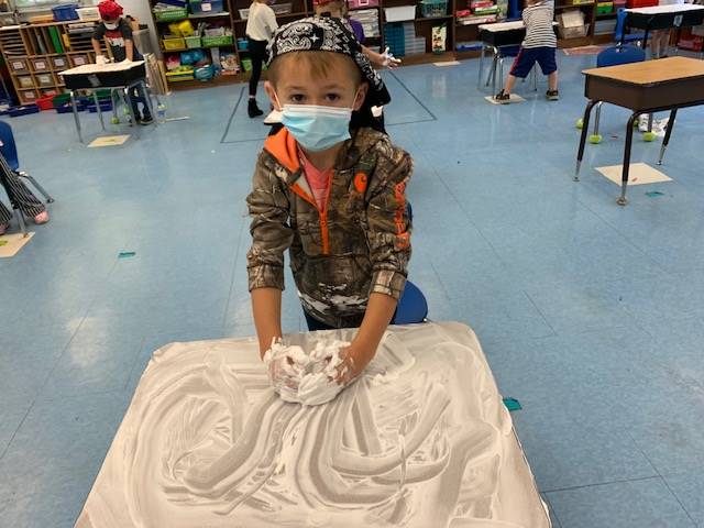 student pirate washes desk ("deck")