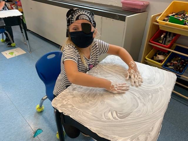 student pirate washes desk ("deck")