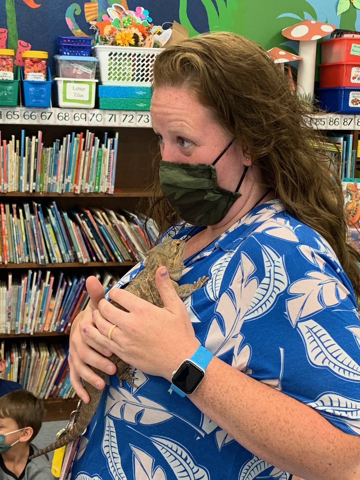 a teacher holds a reptile