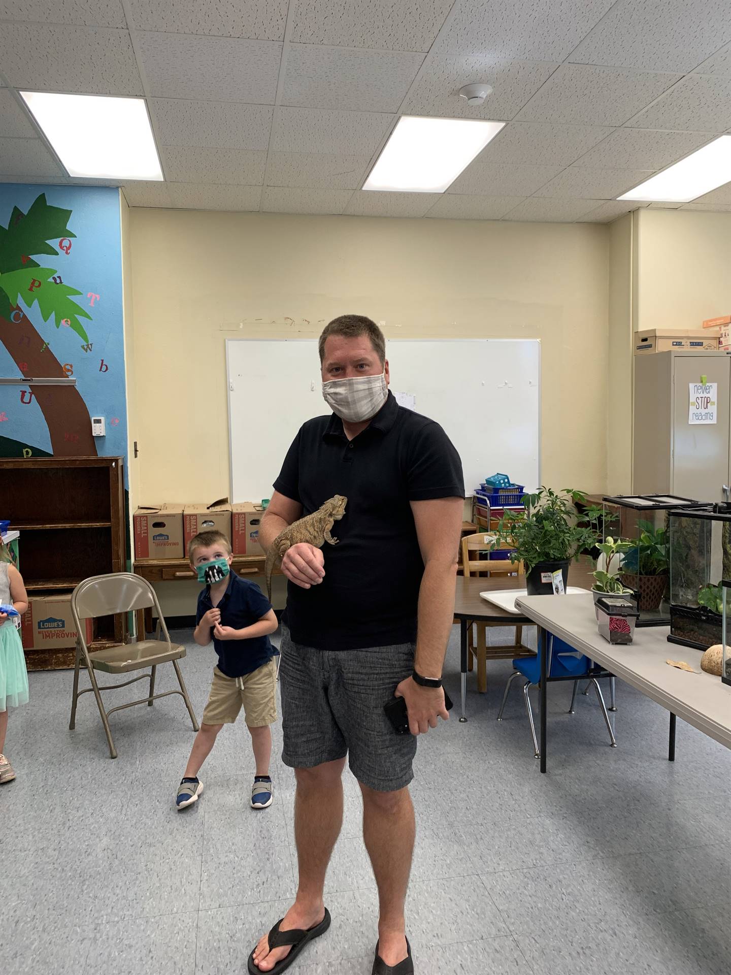 a teacher holds a reptile