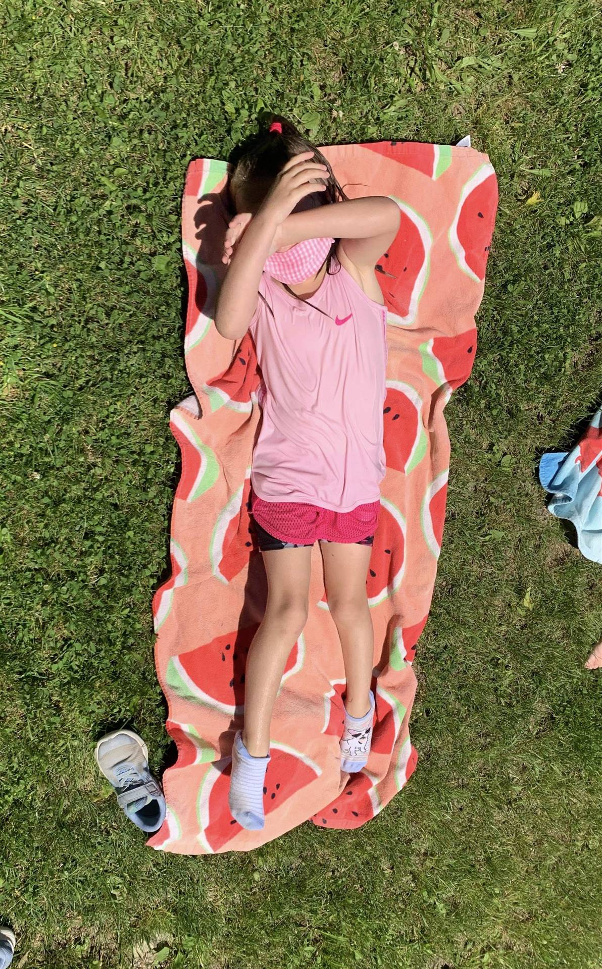 student laying on a beach towel