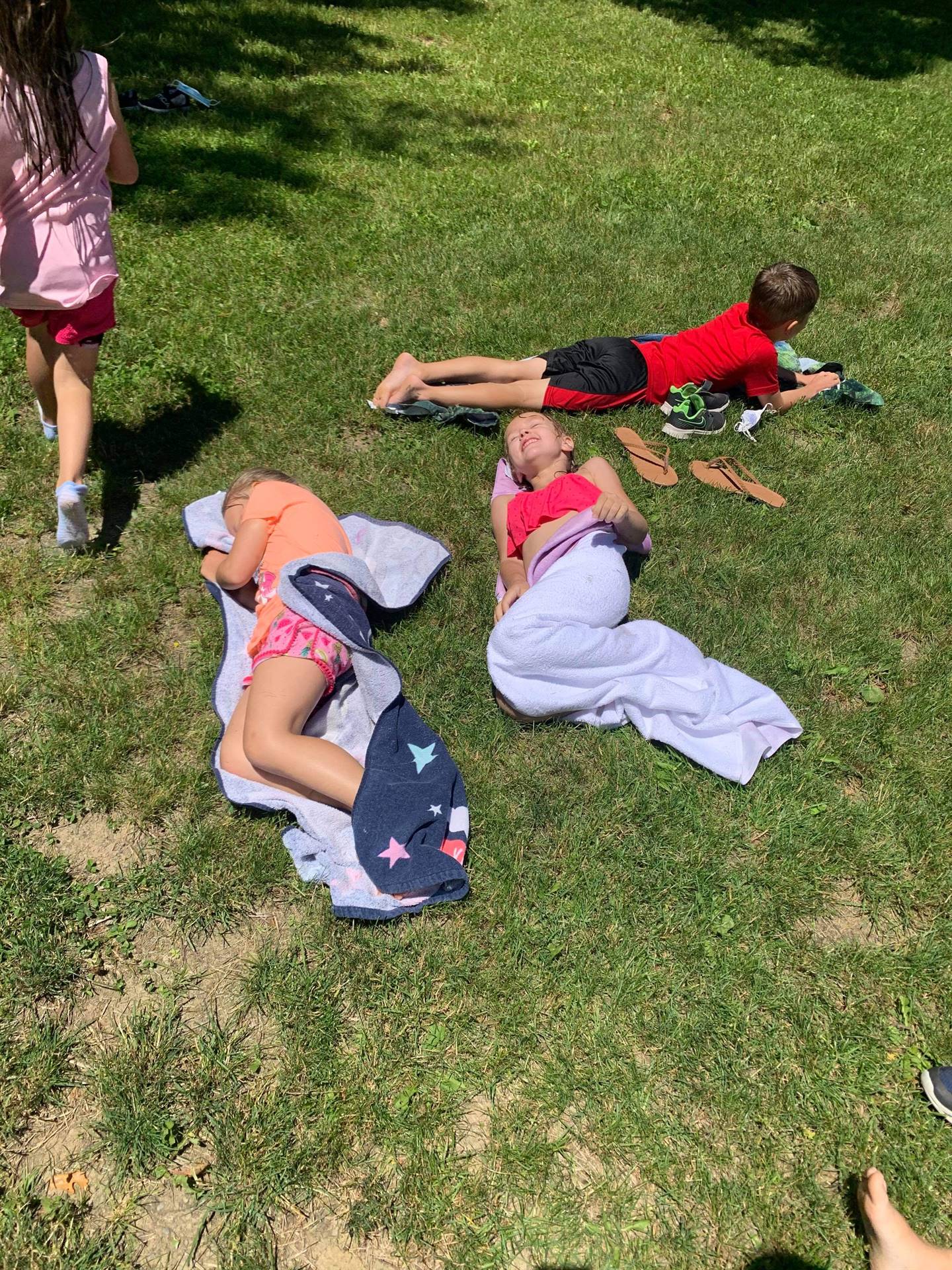 students laying on beach towels
