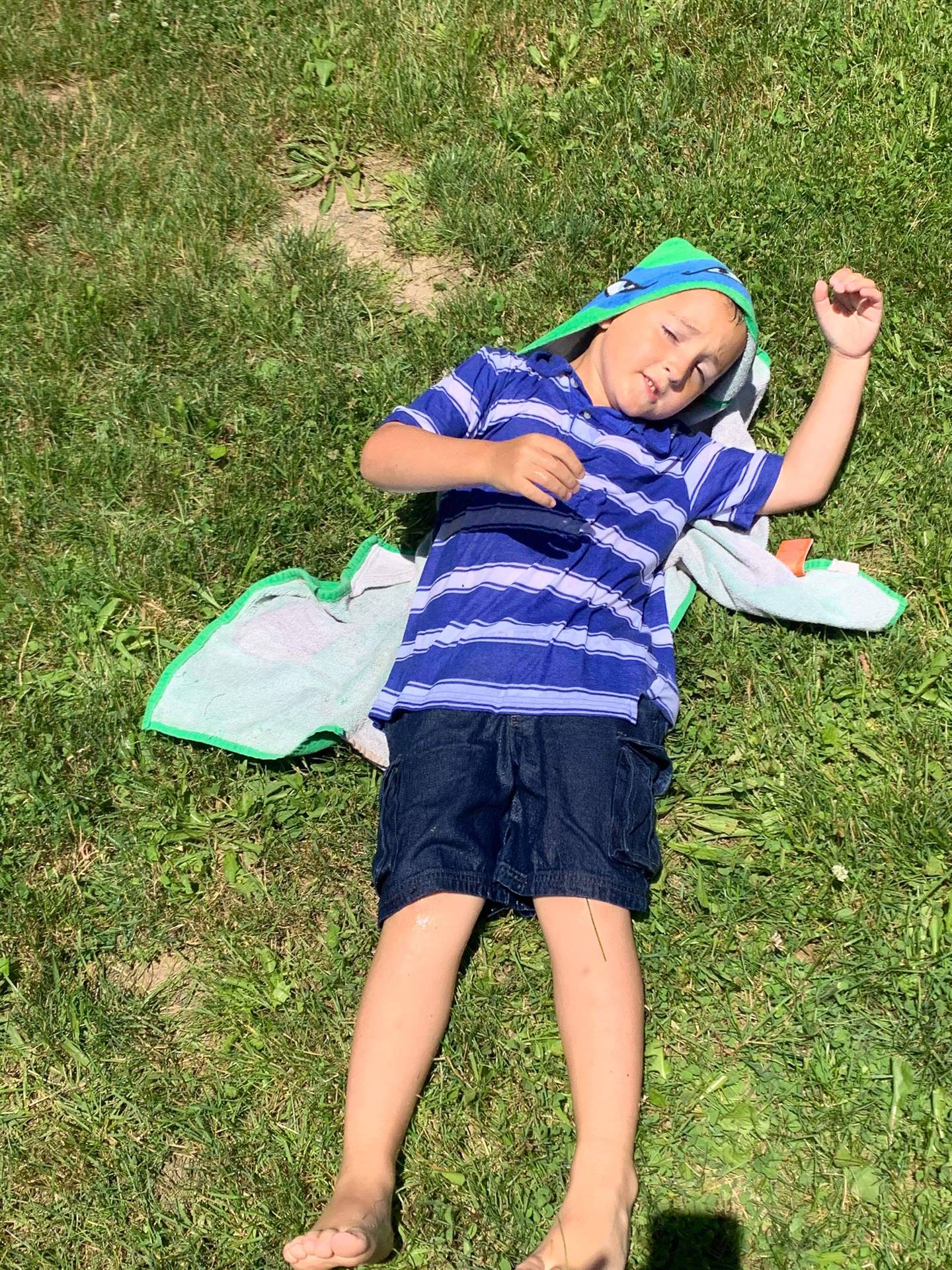 student laying on a beach towel