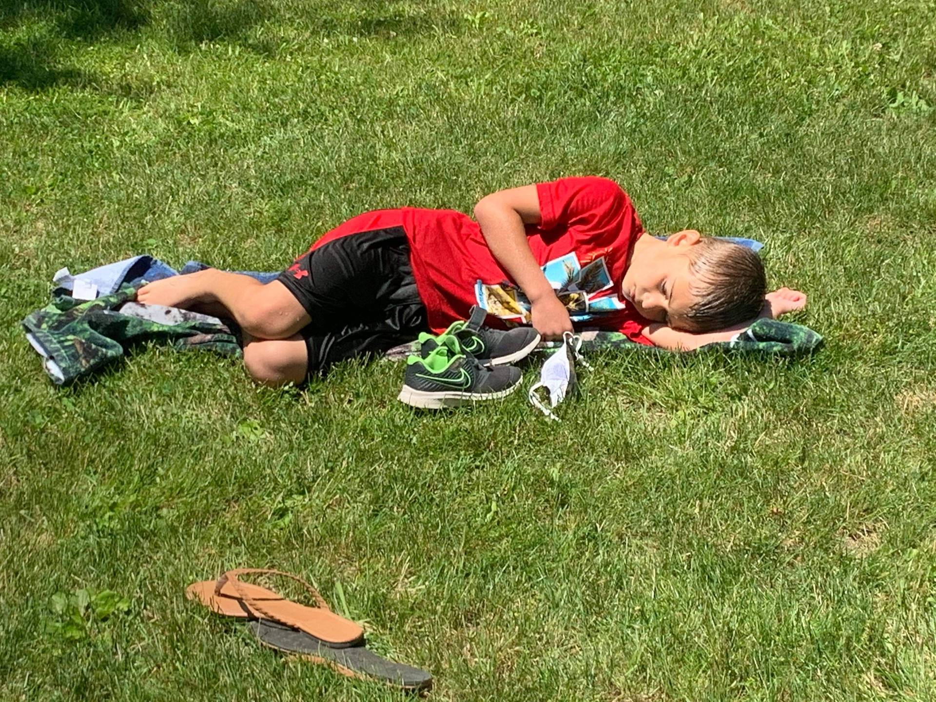 student laying on a beach towel