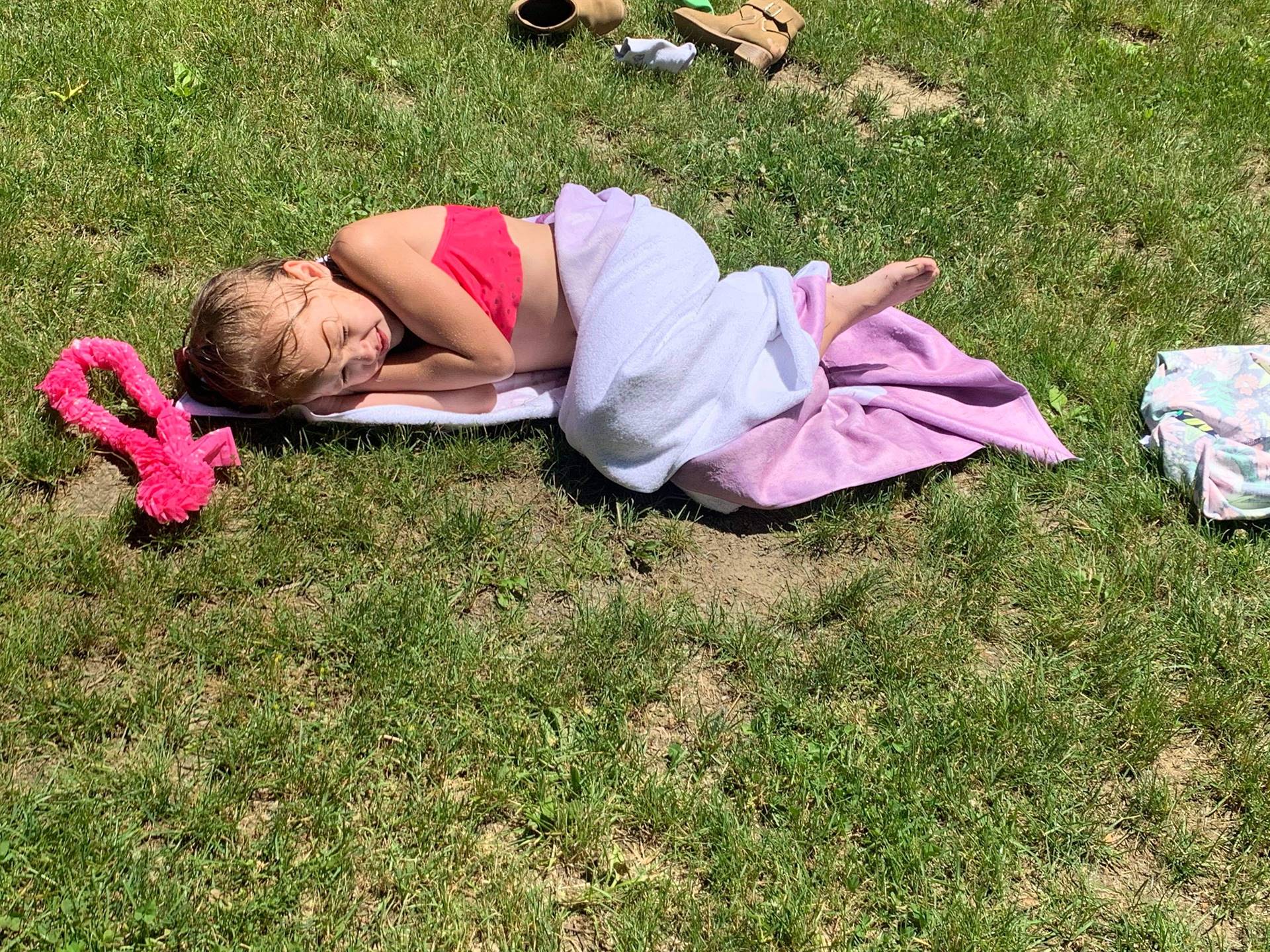 student laying on a beach towel