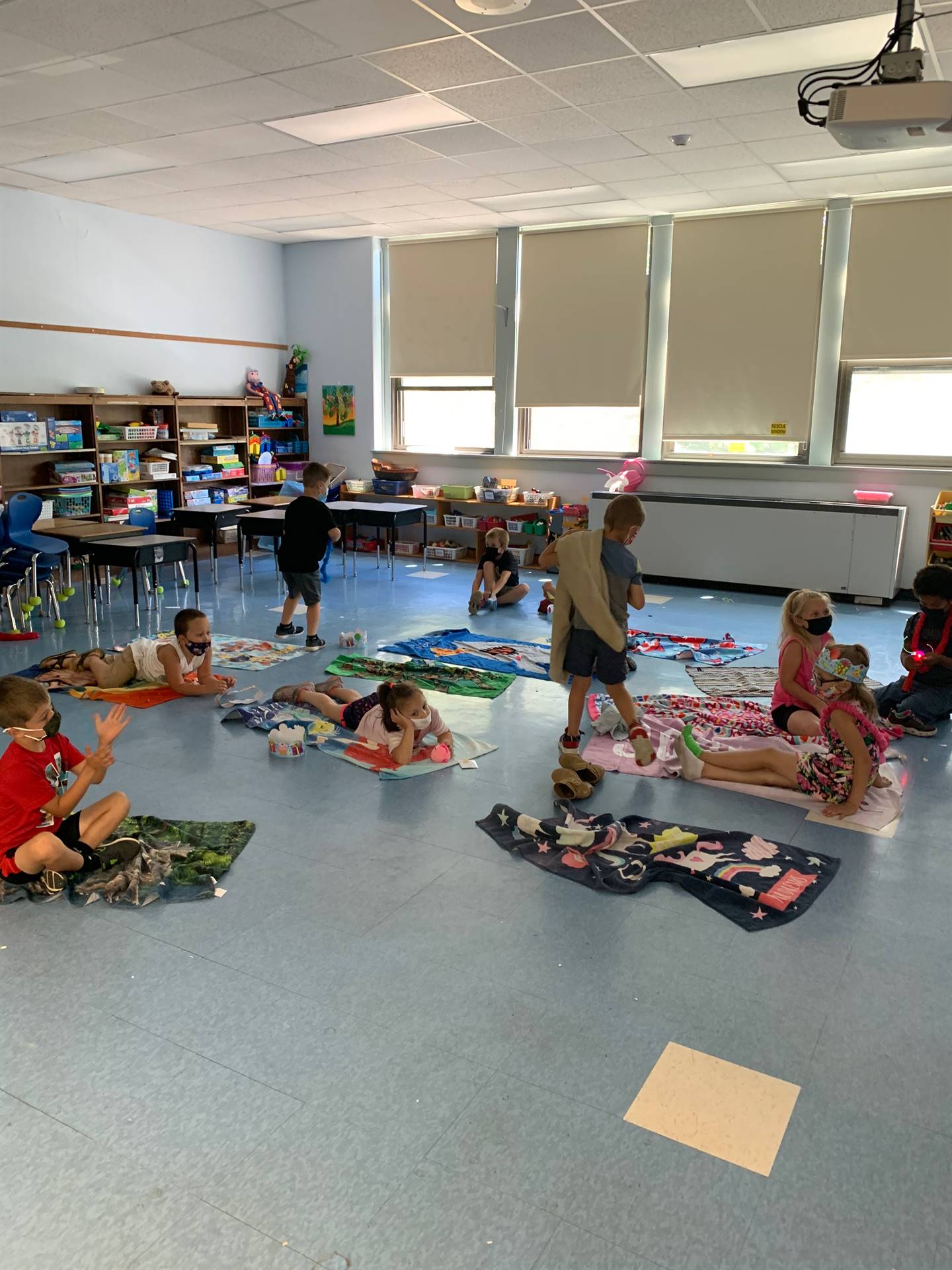 students on a beach towels inside 