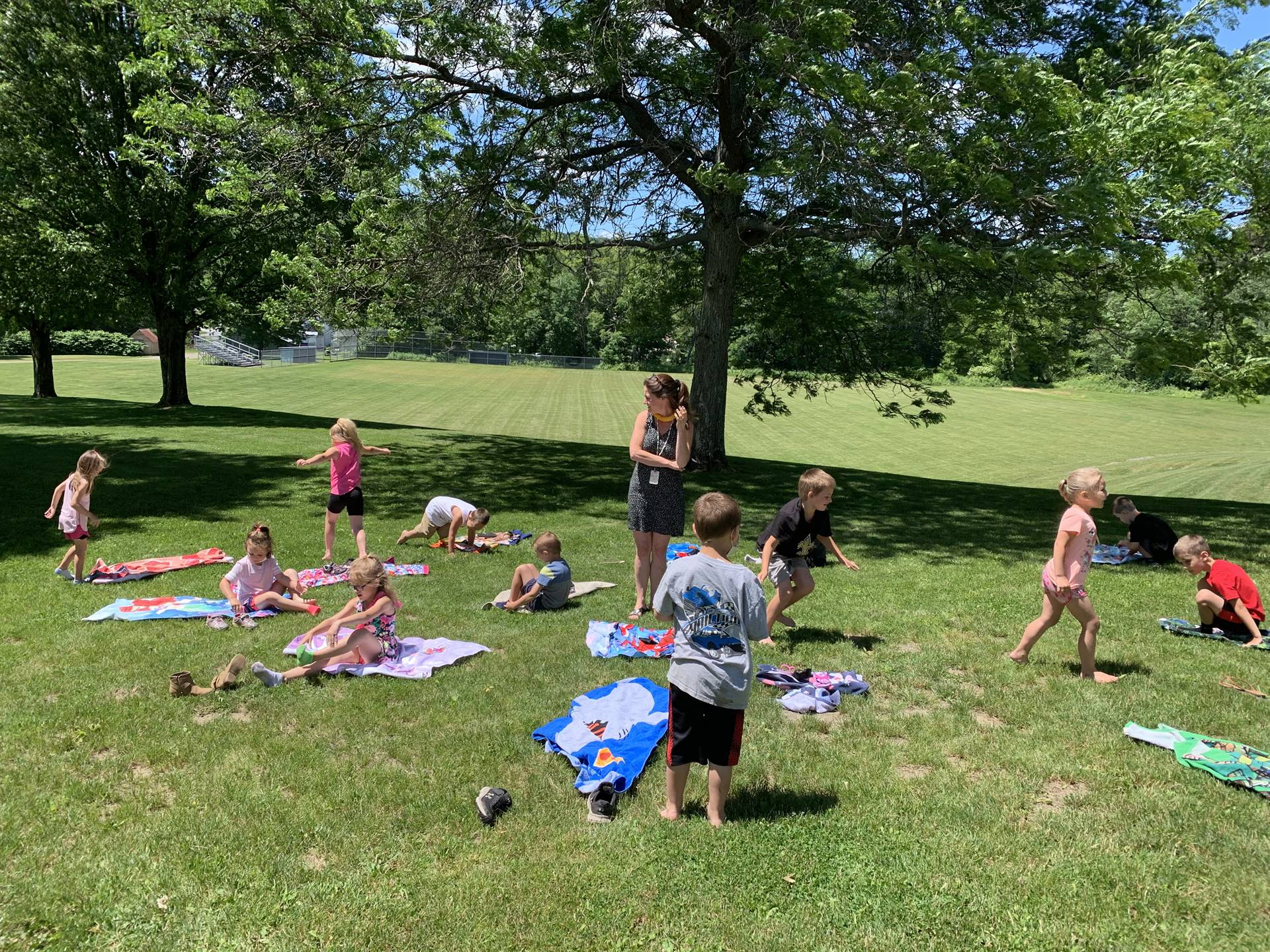 students outdoors playing with water balloons