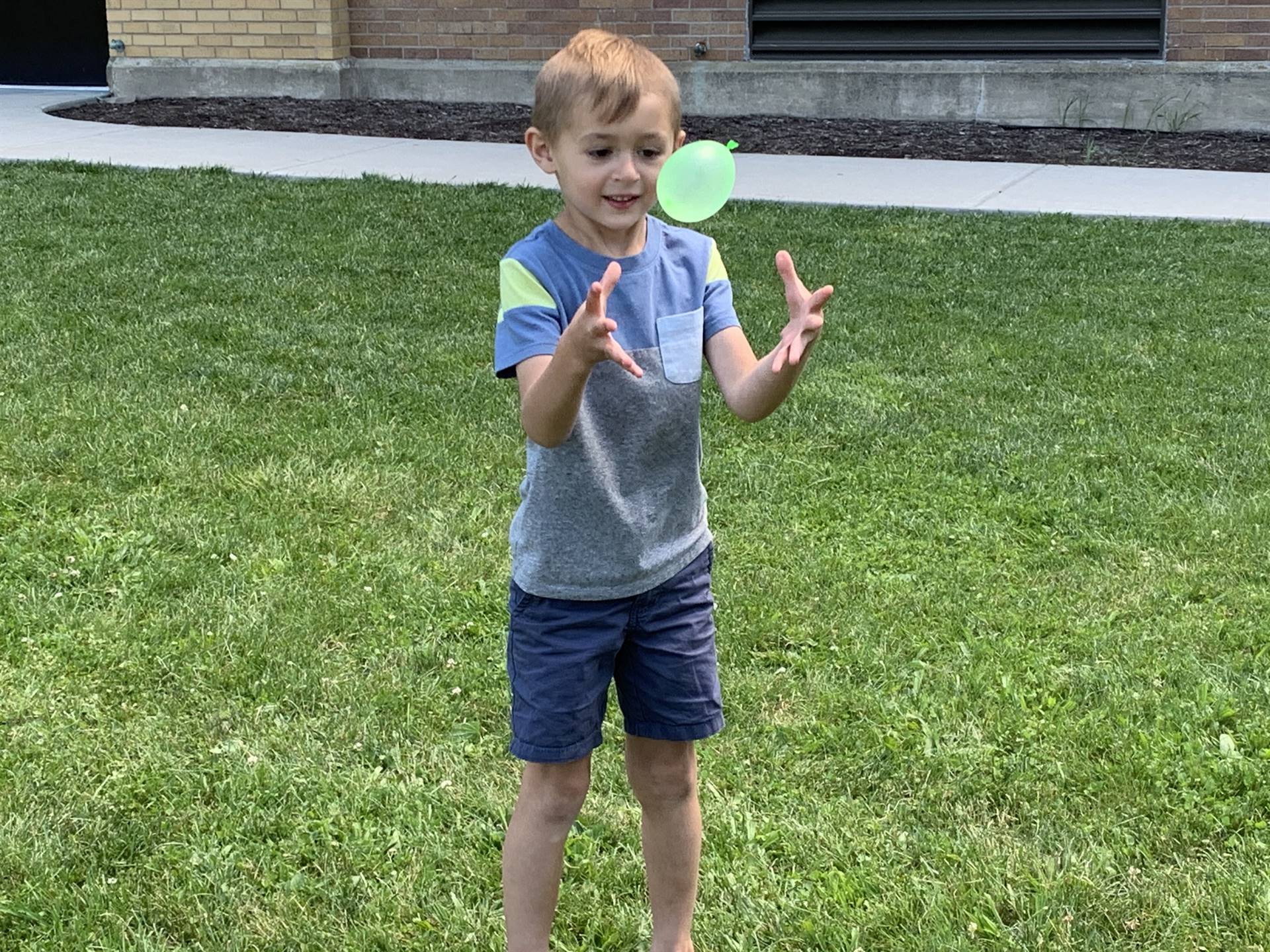 a student tosses water balloon