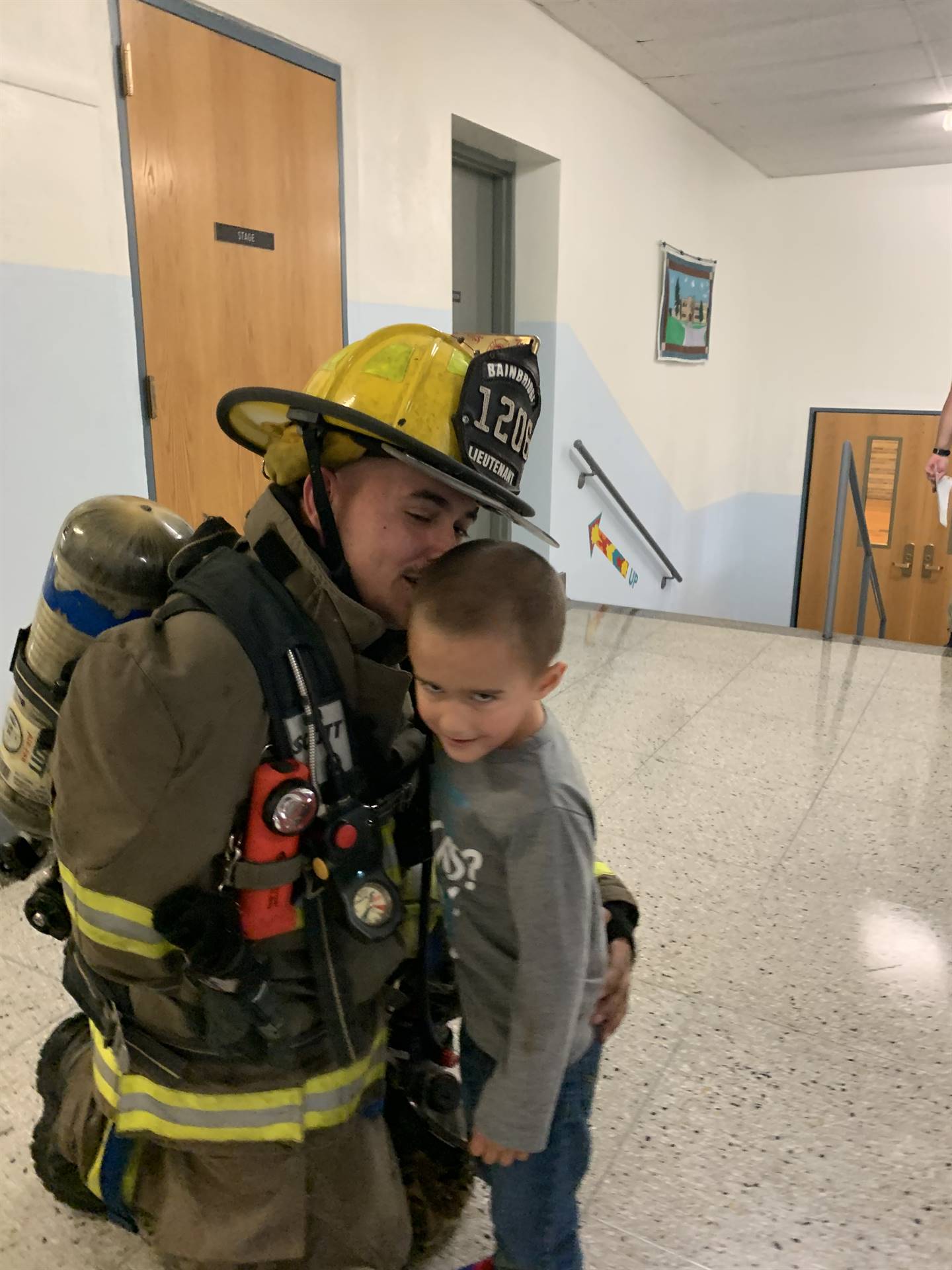 a firefighter with boy.