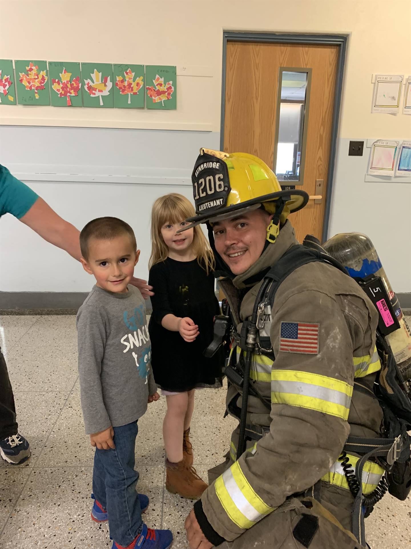 a firefighter with boy and girl