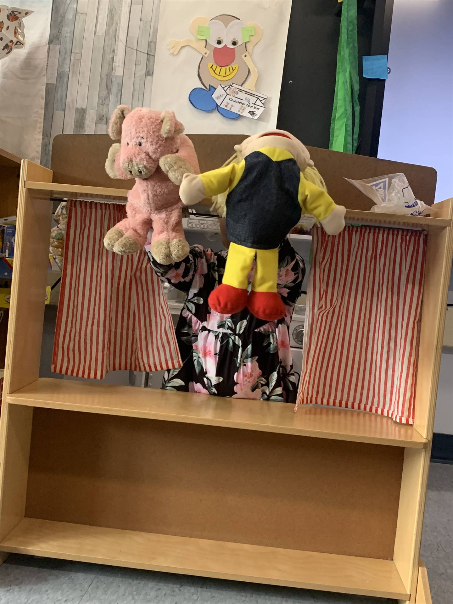 student in puppet theater with a girl and a pig puppet