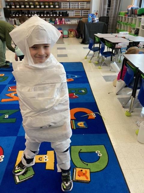 student "mummy" wrapped up in toilet paper.