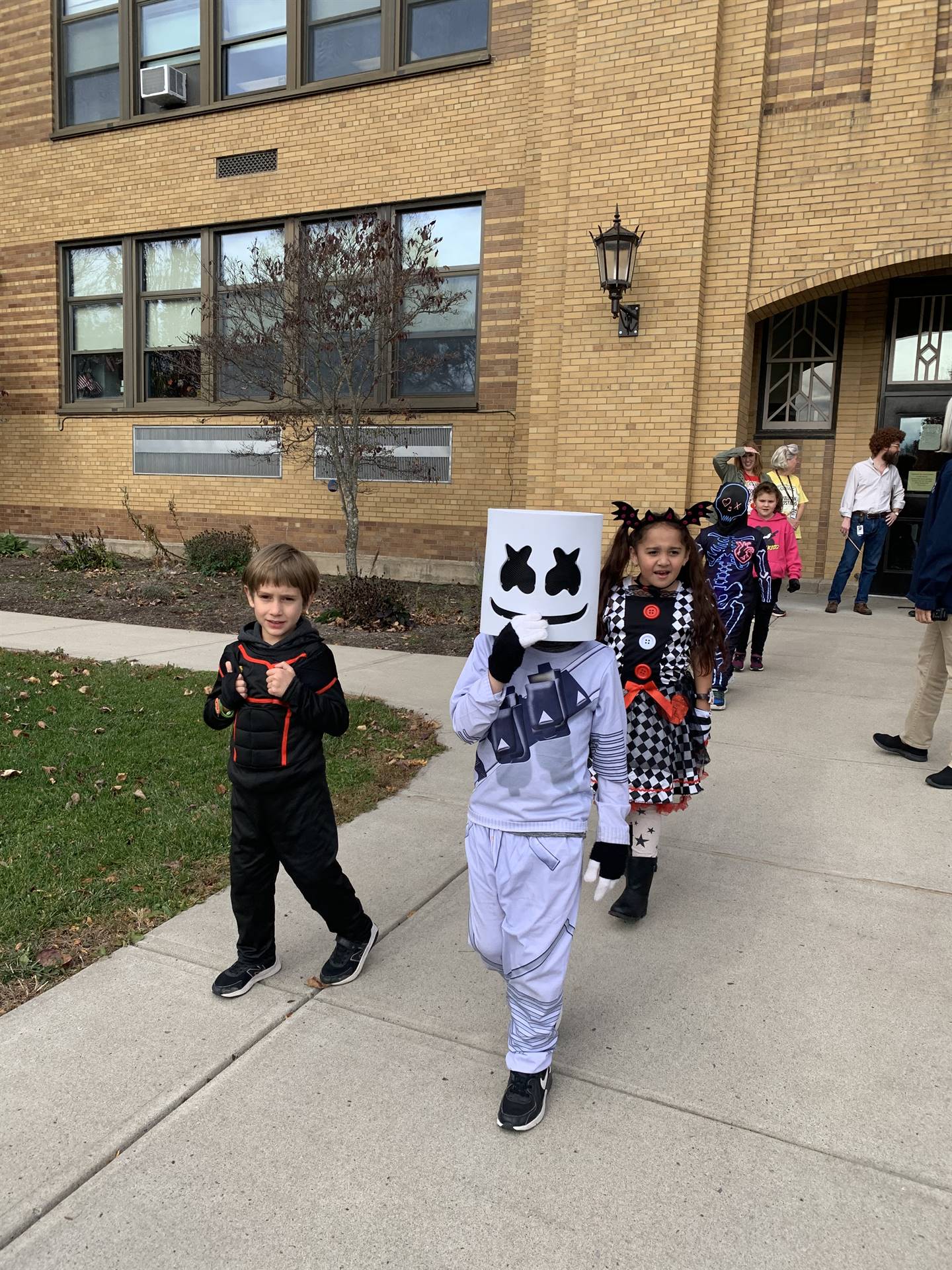students dressed in costume walking out of the school