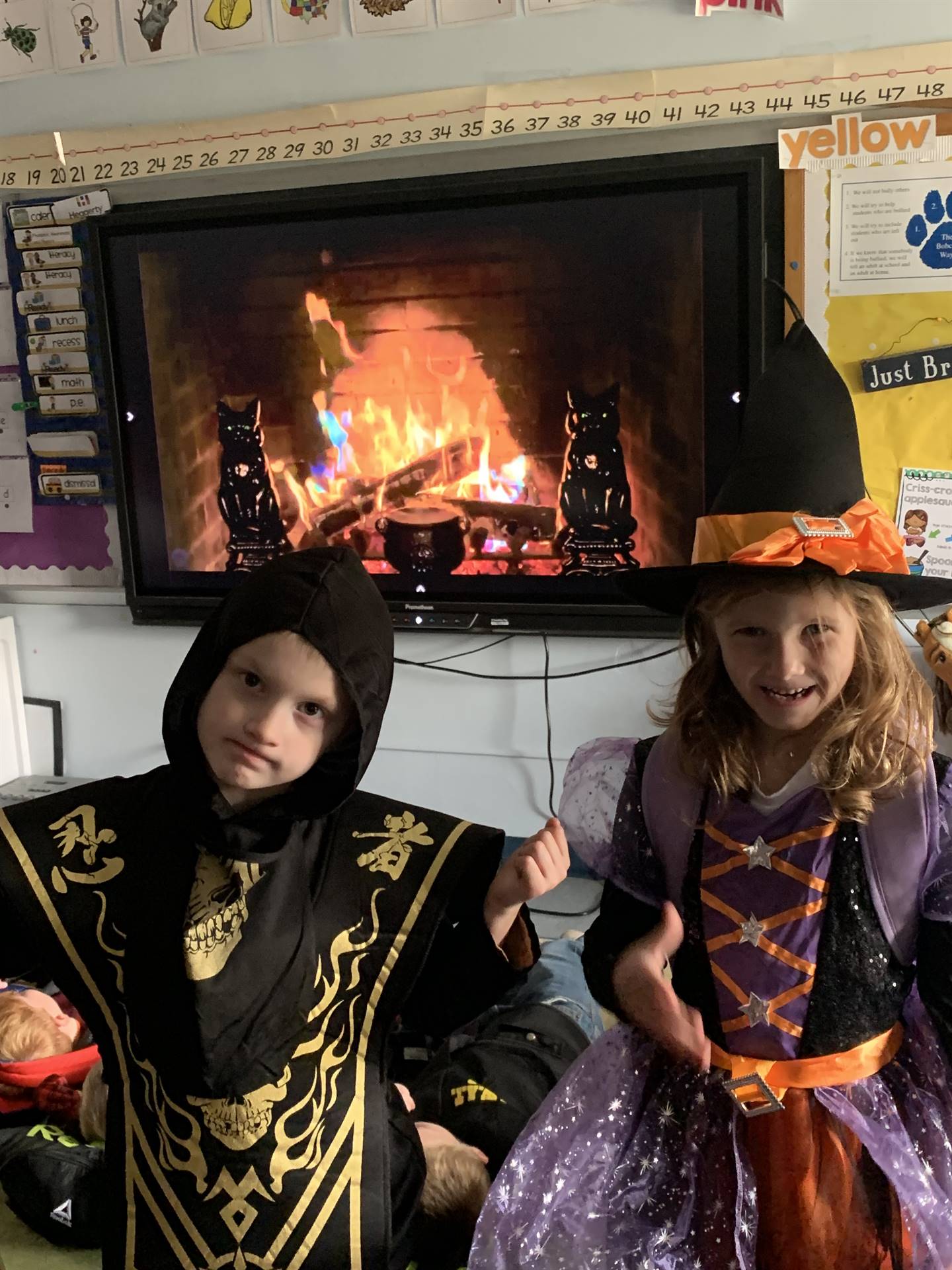 a witch and ninja with fire place background