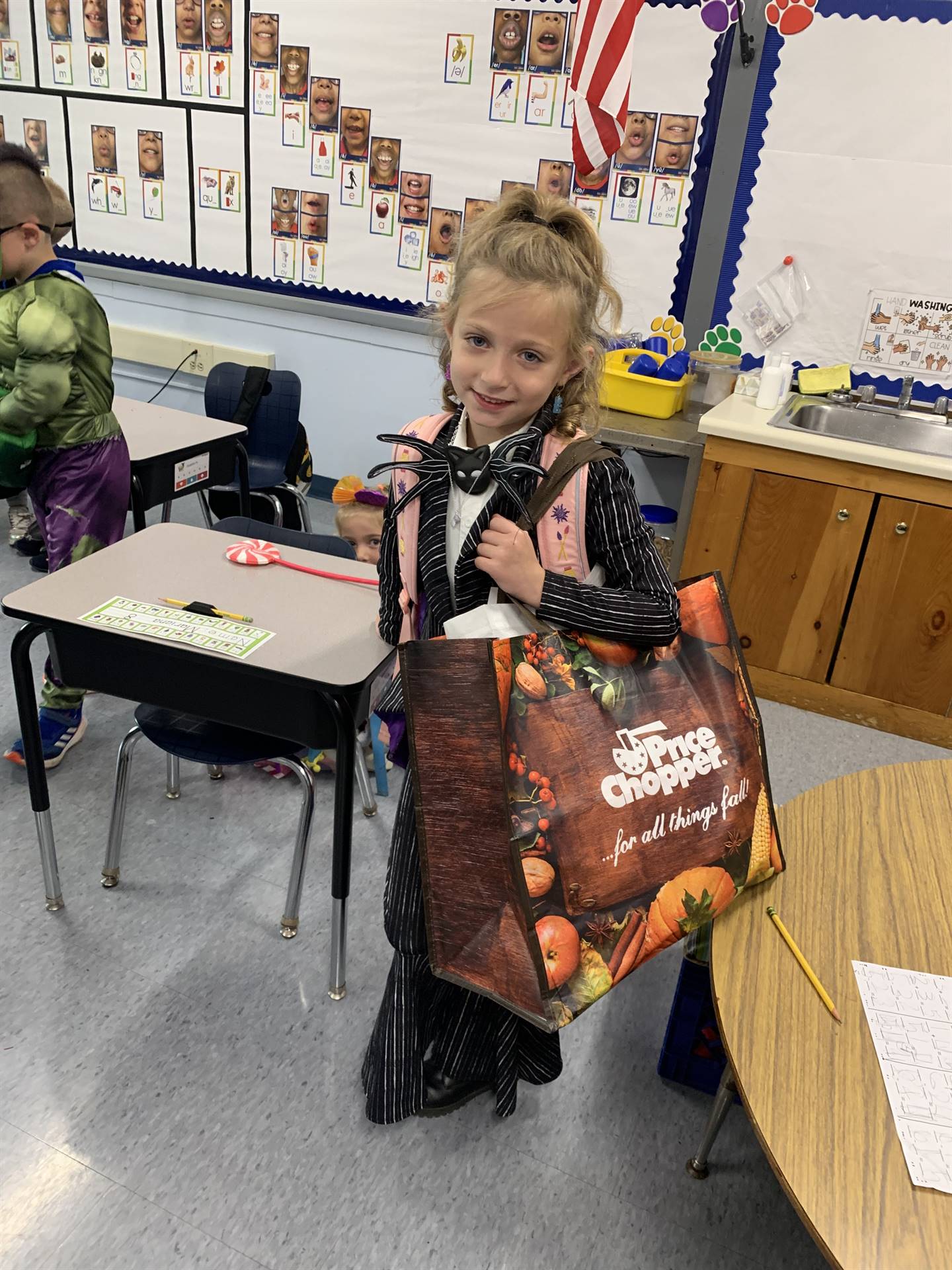 a student dressed up holding a bag