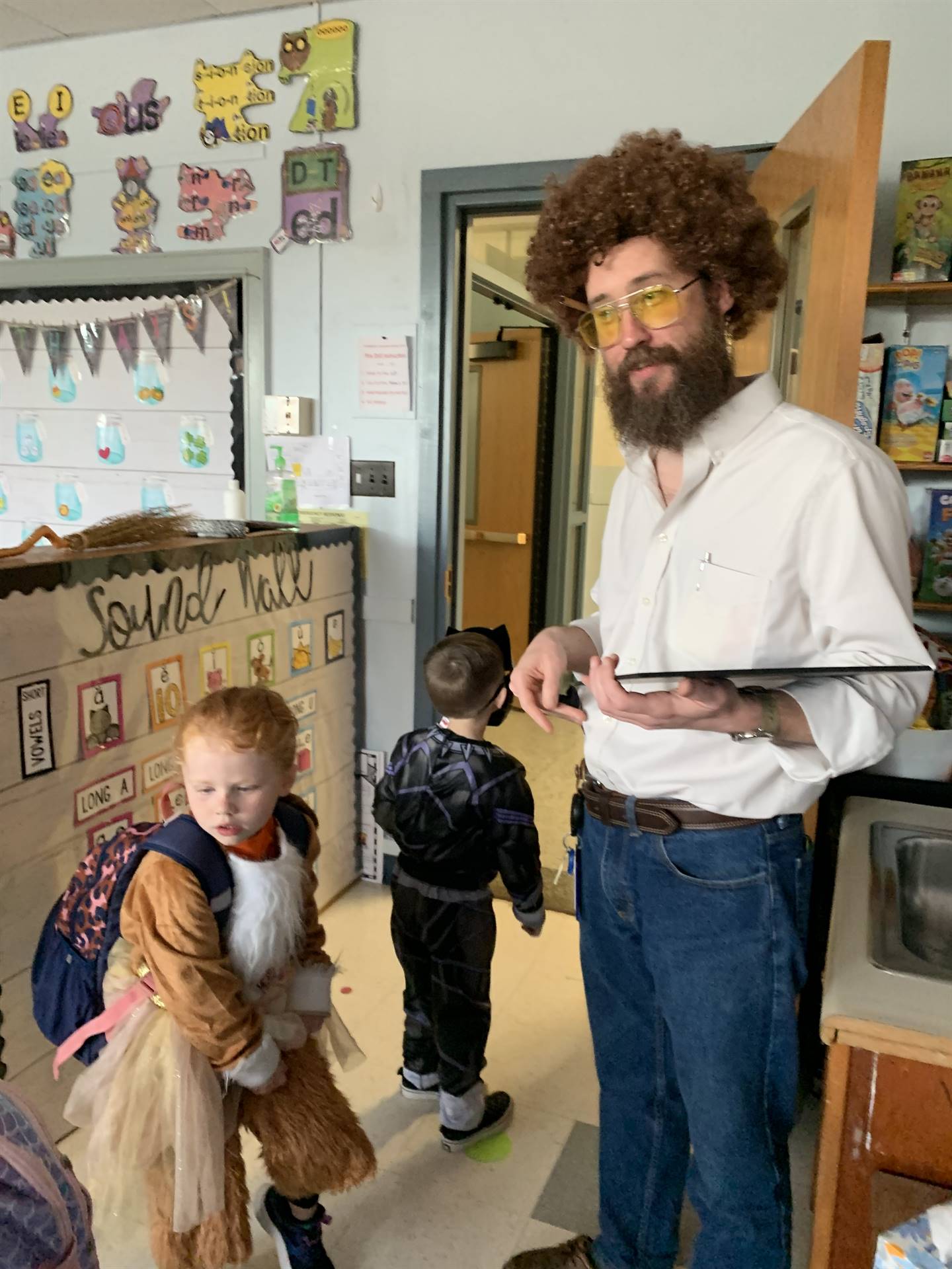 adult dressed as artist bob ross with students.