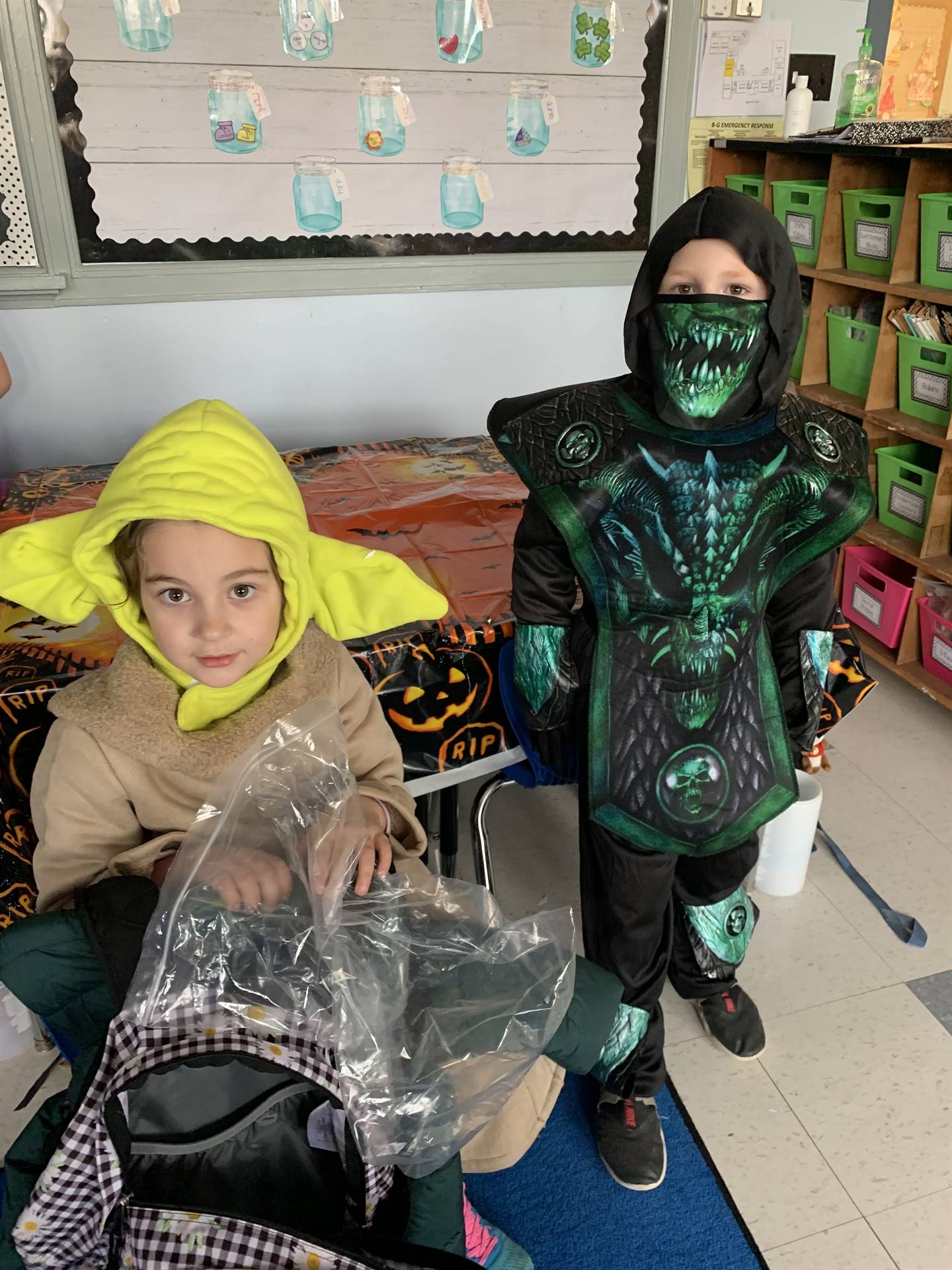 a student dressed as a baby yoda and another as a black and green man.