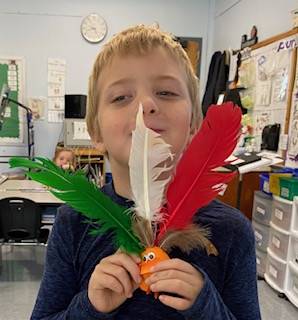 child holding brightly colored feathers 