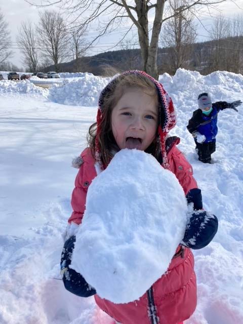 a student licks a giant snowball