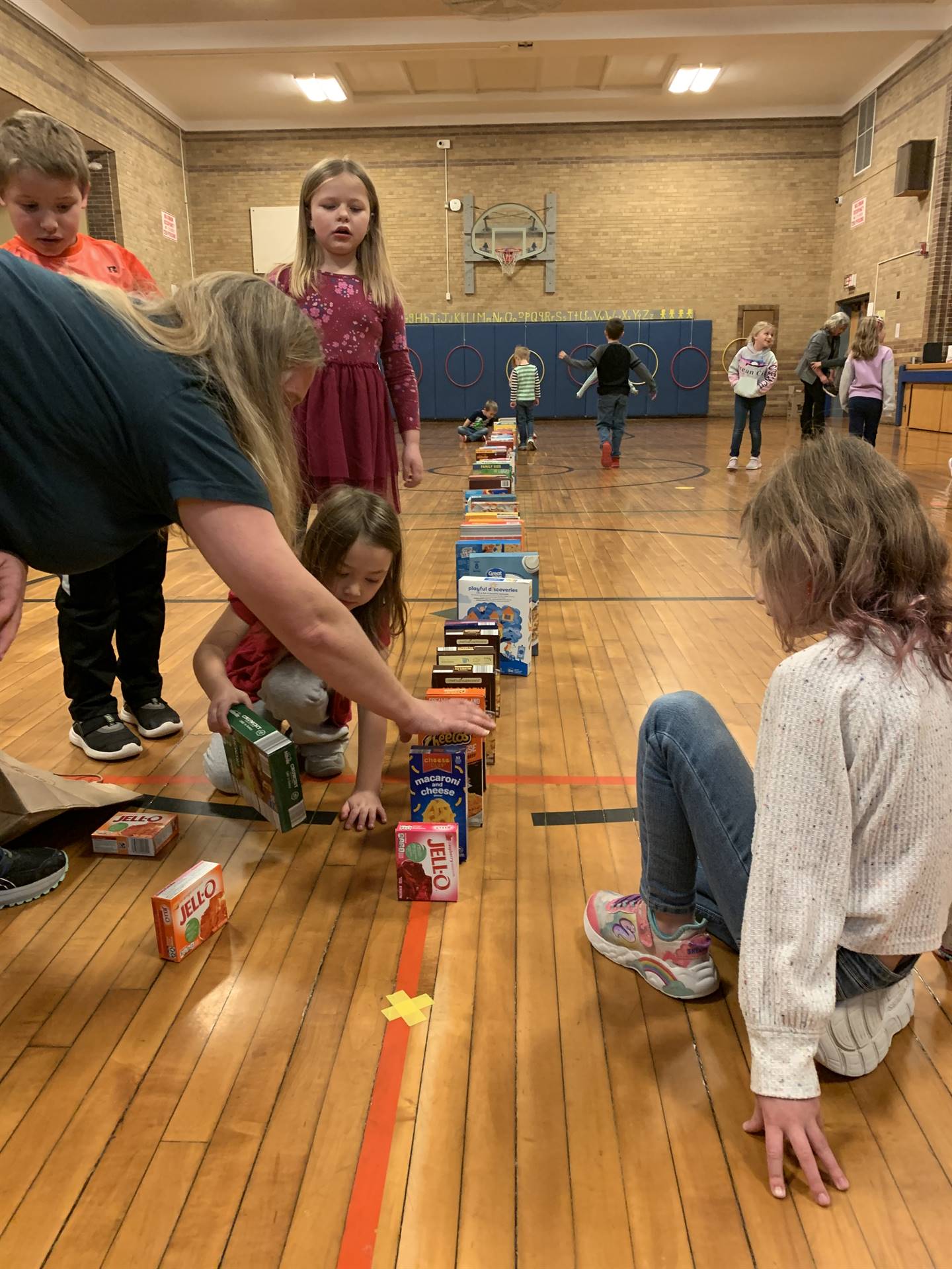 students lining up cereal boxes for a domino effect. 