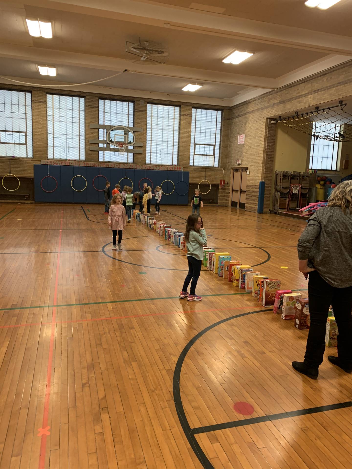 students with lined up cereal boxes for a domino effect to show kindness. 