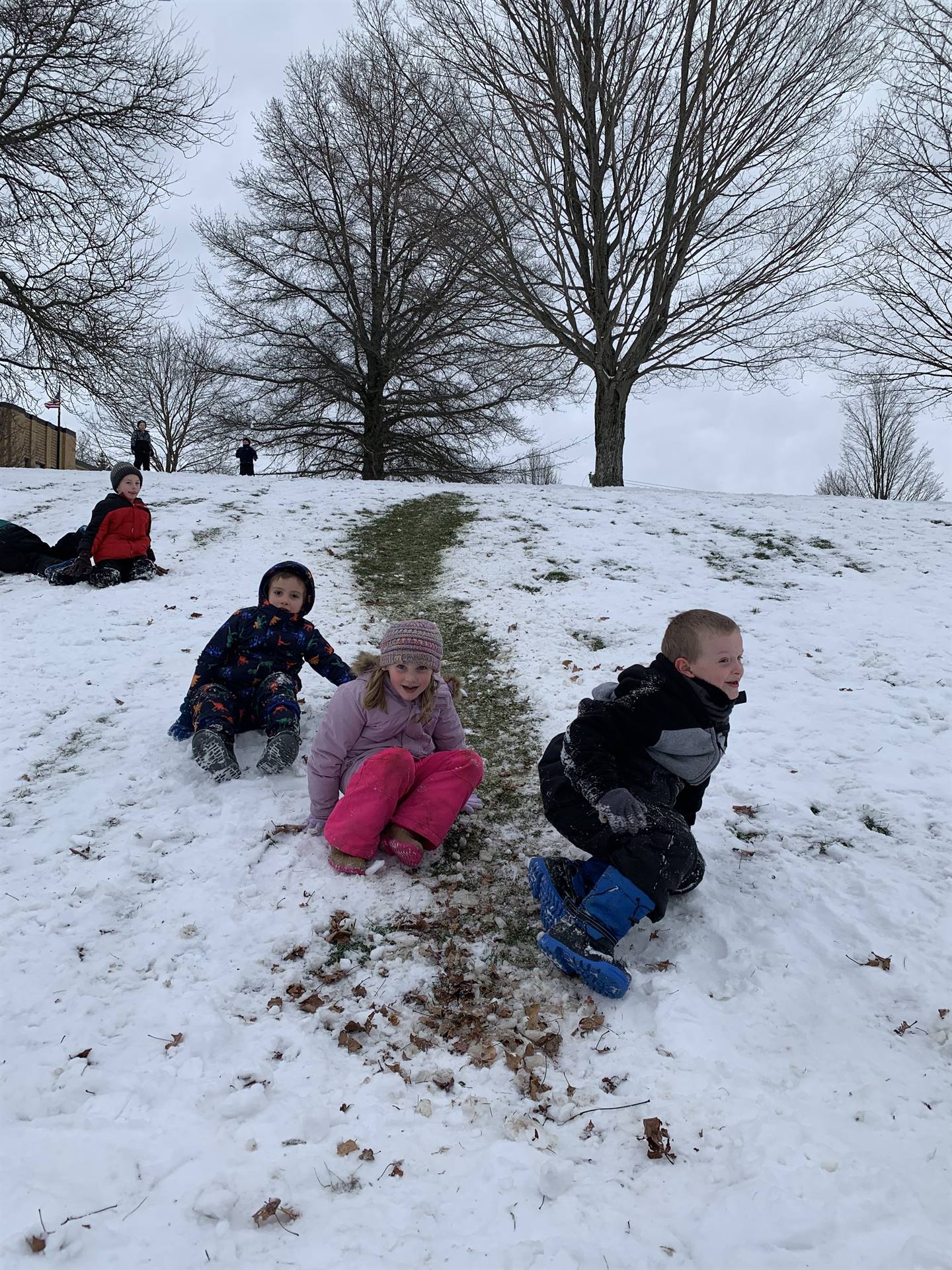 kids lying in snow