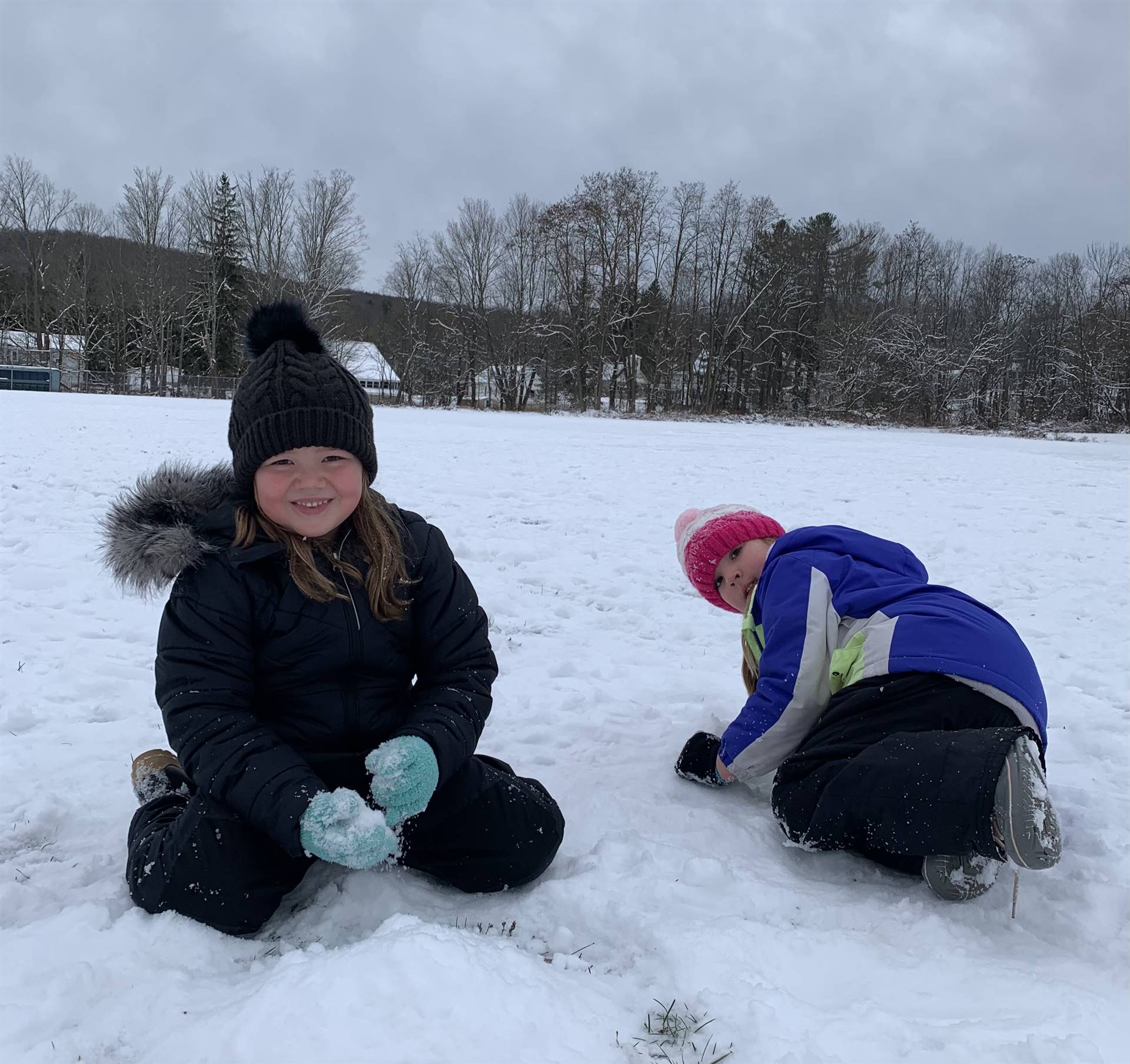 2 kids playing in snow