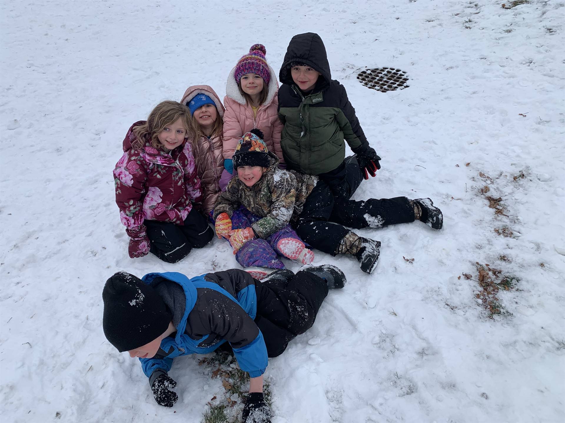 a group of students huddled on snow-covered ground