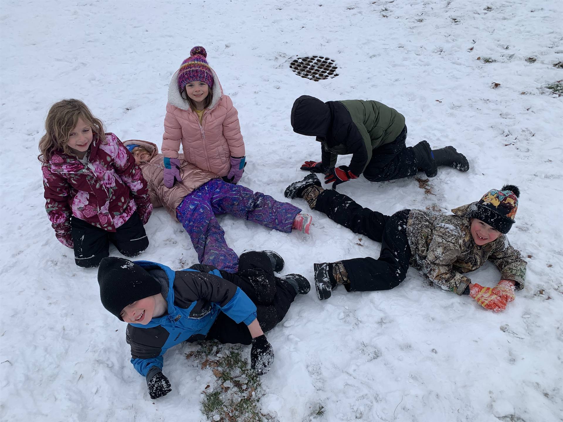 a group of students piled up in snow