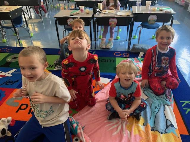4 children on blankets with pajamas on. 