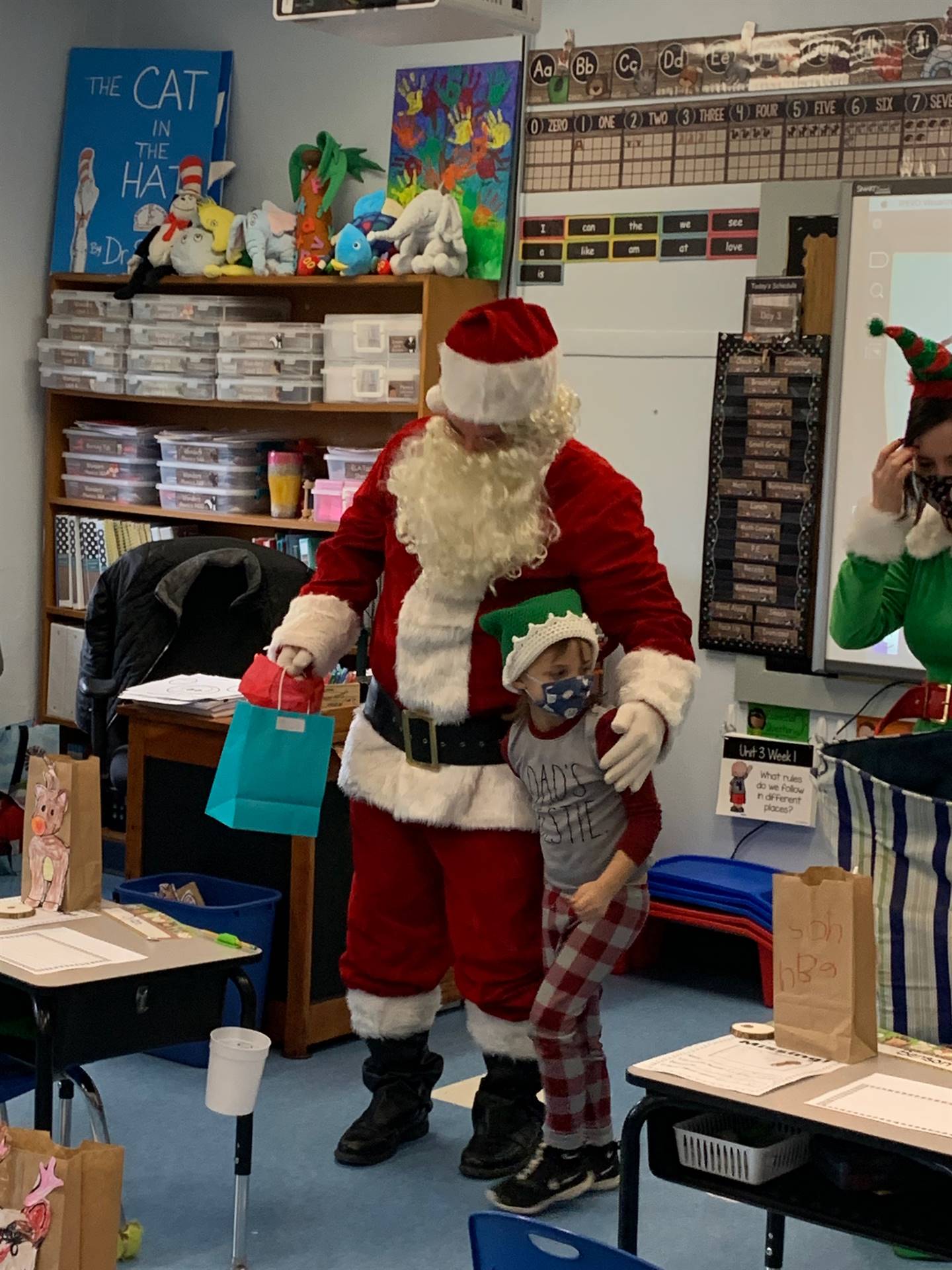 A student hugs Santa.