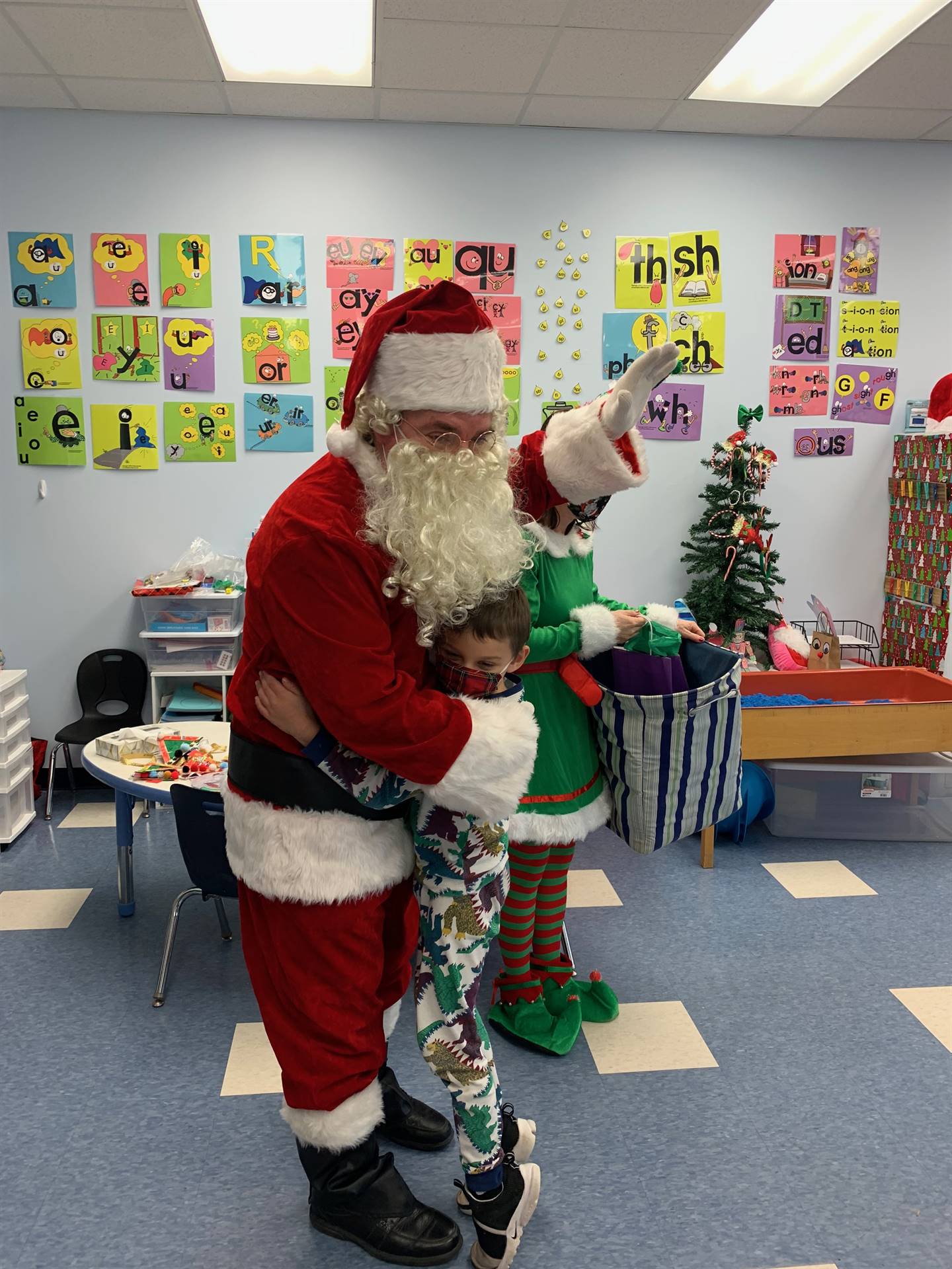 a student hugs Santa.
