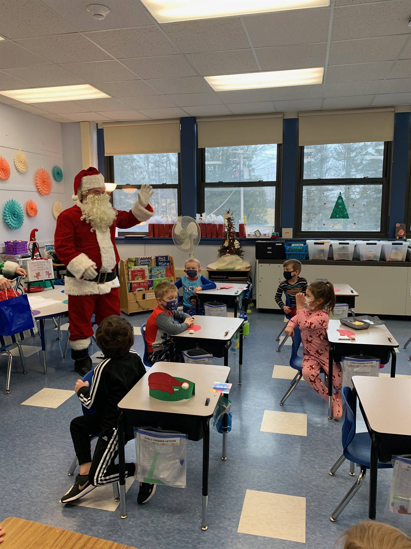 Santa waves to a class of students!
