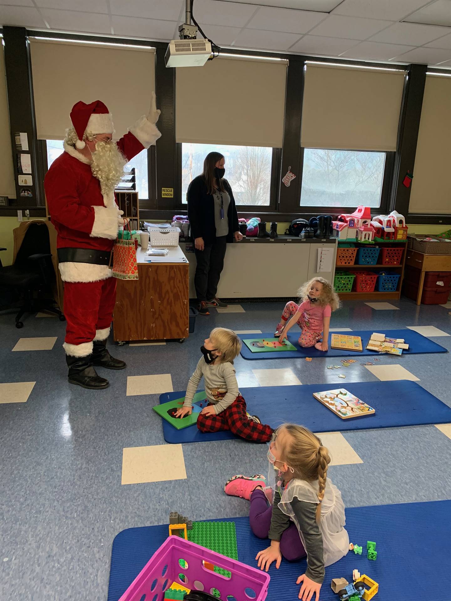 Santa talks with a class of Pre K students. 