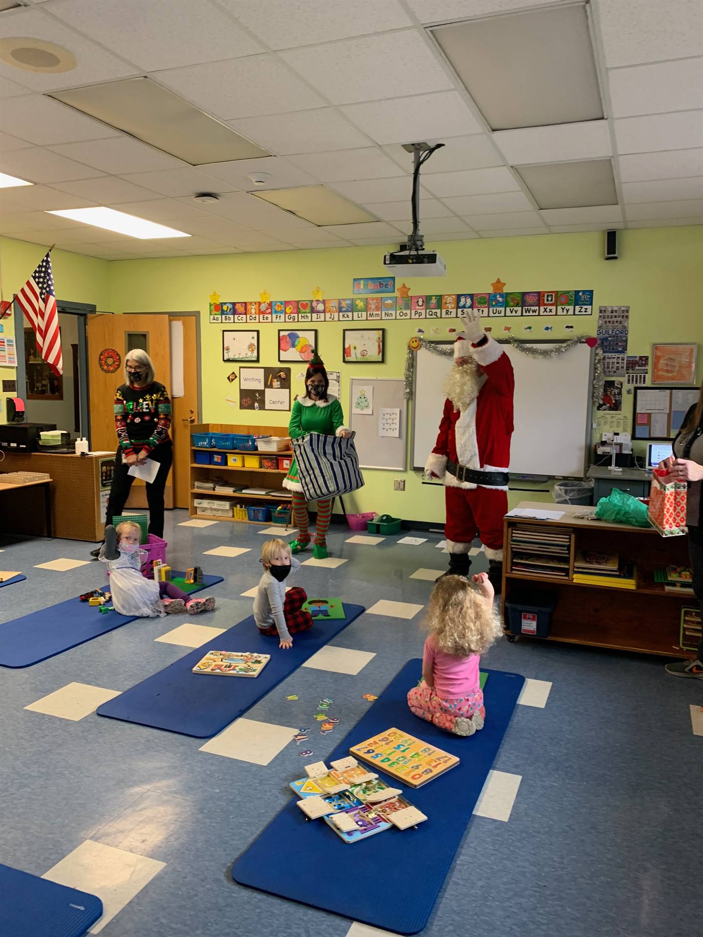 students listen to Santa and his elf 
