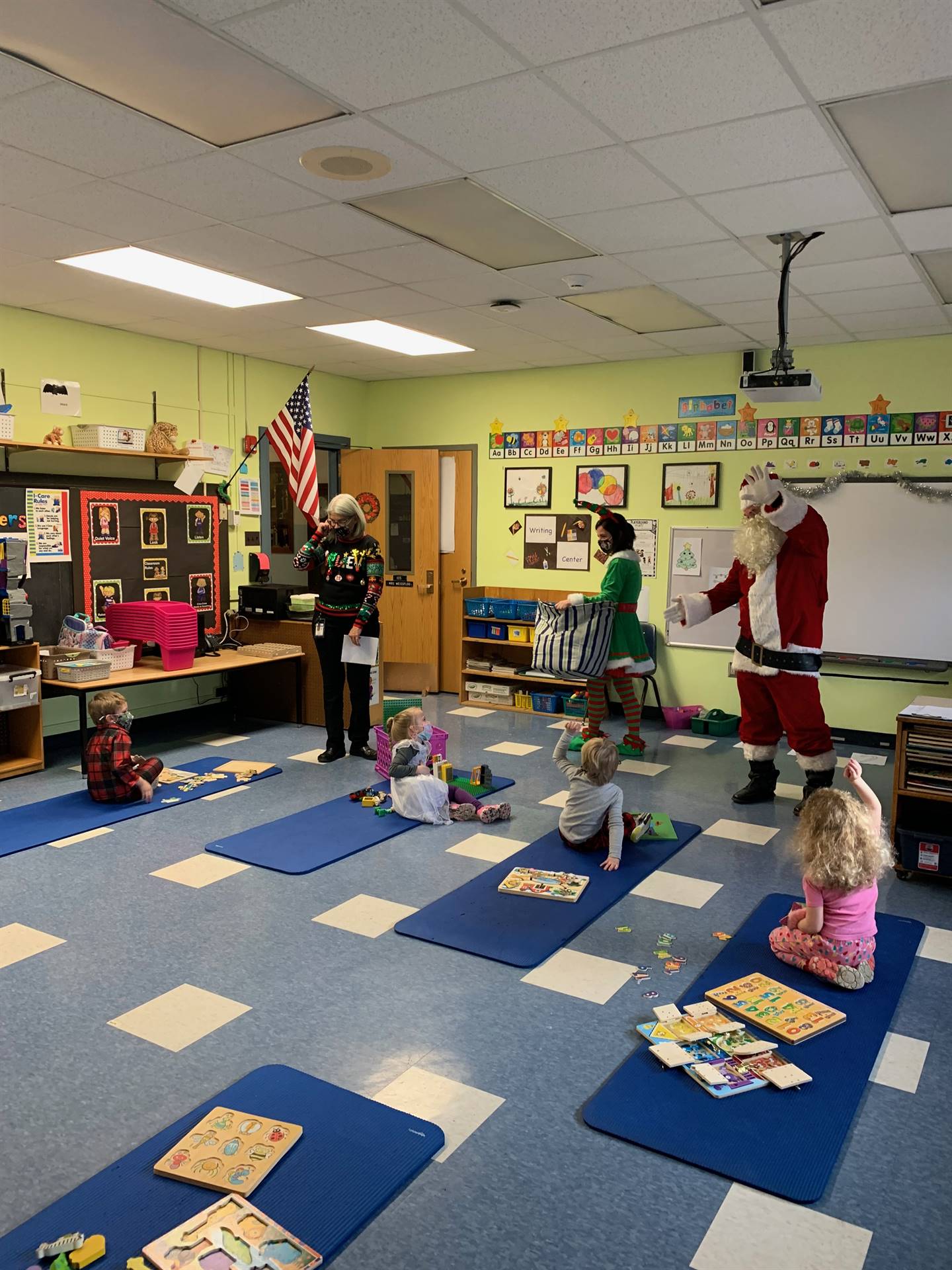 students listen to Santa and his elf 