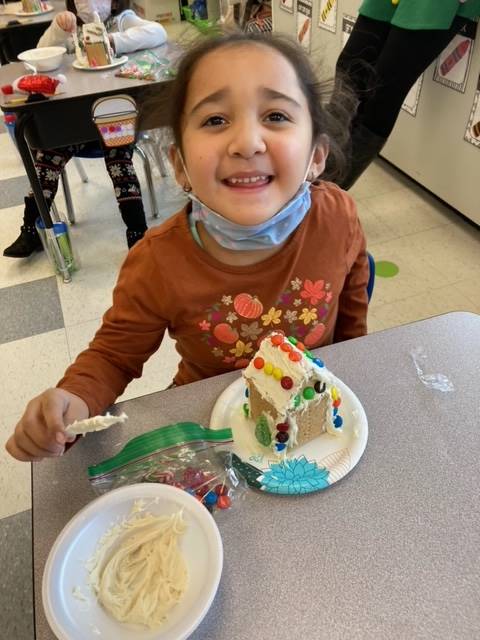student with gingerbread house.
