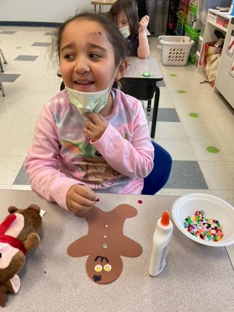student with paper gingerbread man 