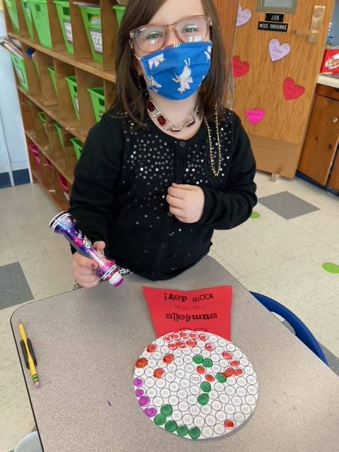 student paint dotting 100 gumballs for 100th day.
