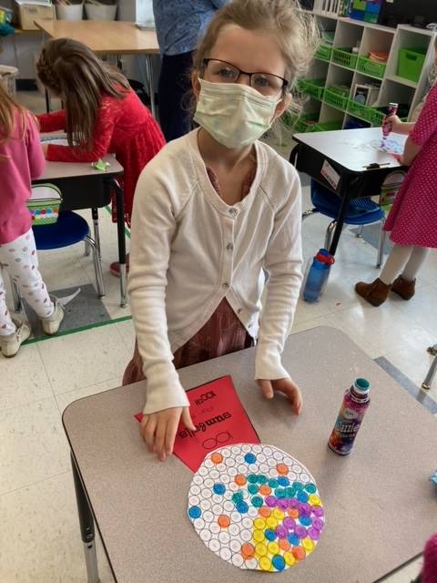 student paint dotting 100 gumballs for 100th day.
